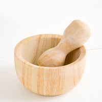 1: Large mortar and pestle with both pieces made from variegated tan-colored sandstone
