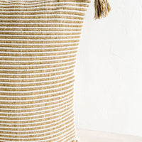 4: Textured, striped woven cotton pillow in brown and ivory with matching tassels at corners