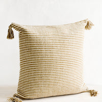 Light Brown: Large square throw pillow in textured light brown and cream stripes, decorative tassel at each corner