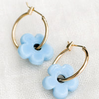 Sky Blue: A pair of gold hoop earrings with single cyan flower bead.