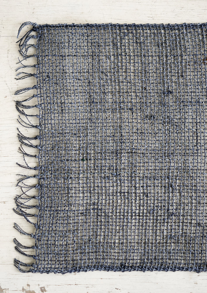 A blue-grey woven straw placemat.