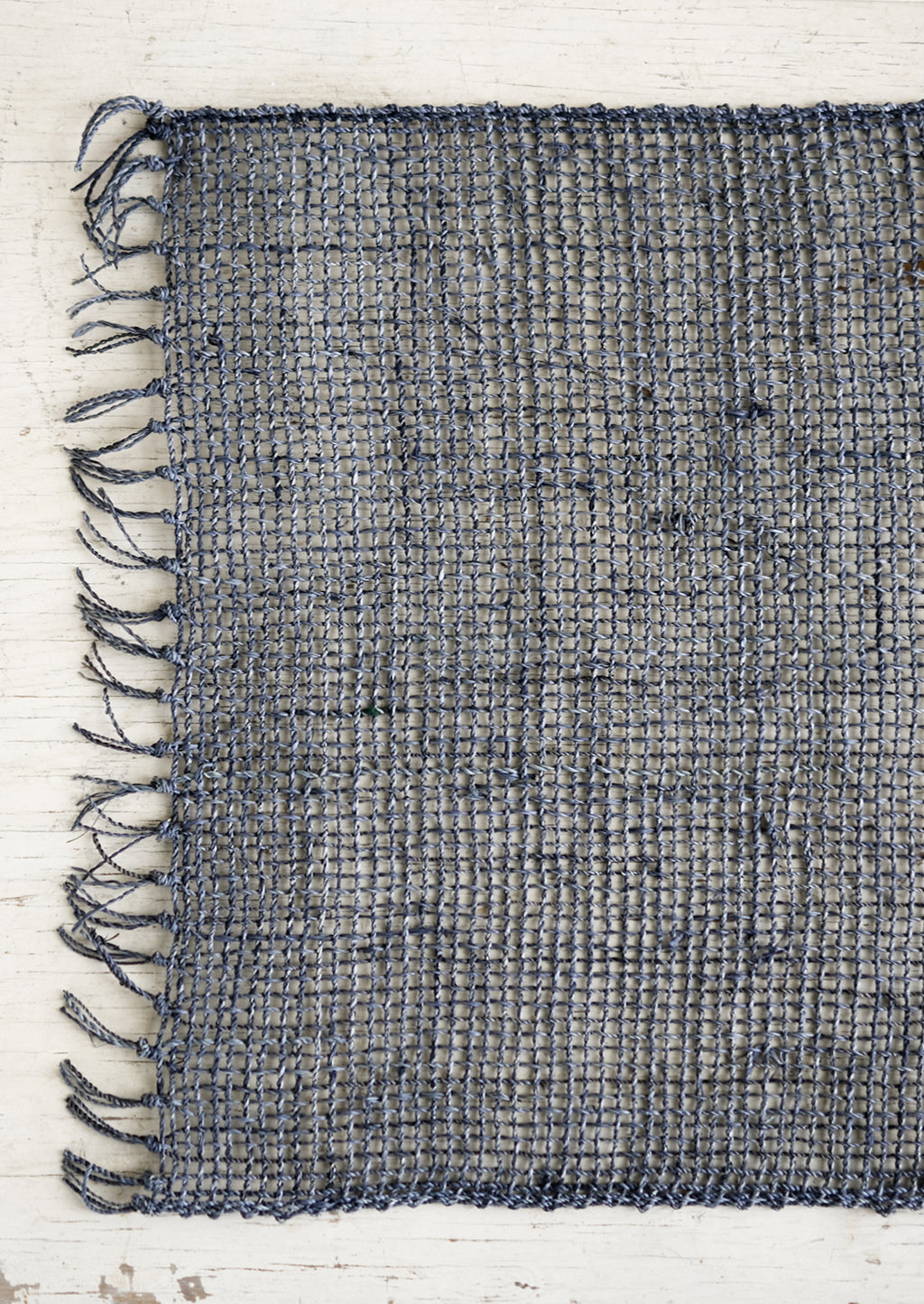 Riverstone: A blue-grey woven straw placemat.