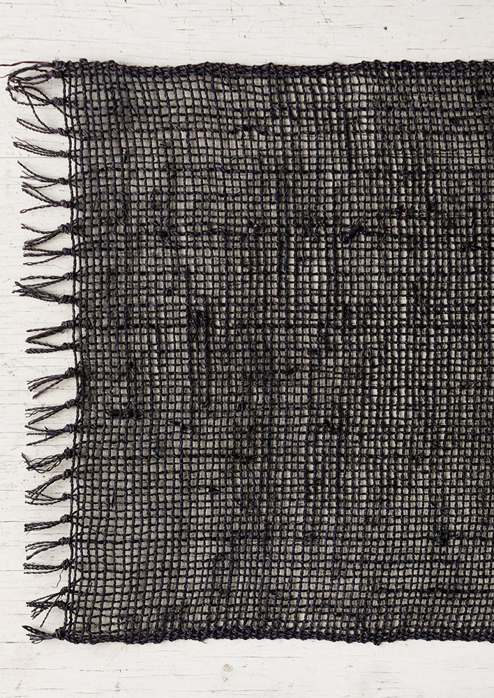 A black woven straw placemat.