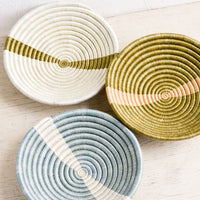 1: Three small sweetgrass catchall bowls in earthy tones.
