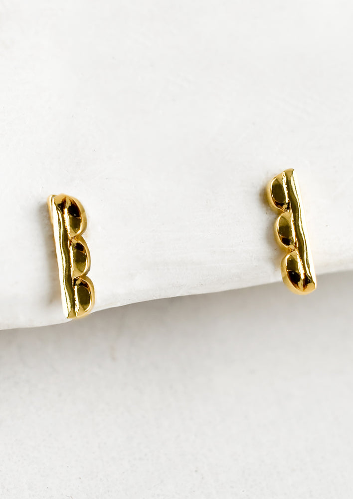 1: A pair of bar shaped stud earrings with scalloped edge.