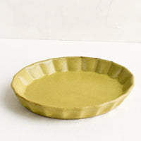 Matte Chartreuse: A small, oval shaped shallow dish with pleated edge in matte chartreuse glaze.