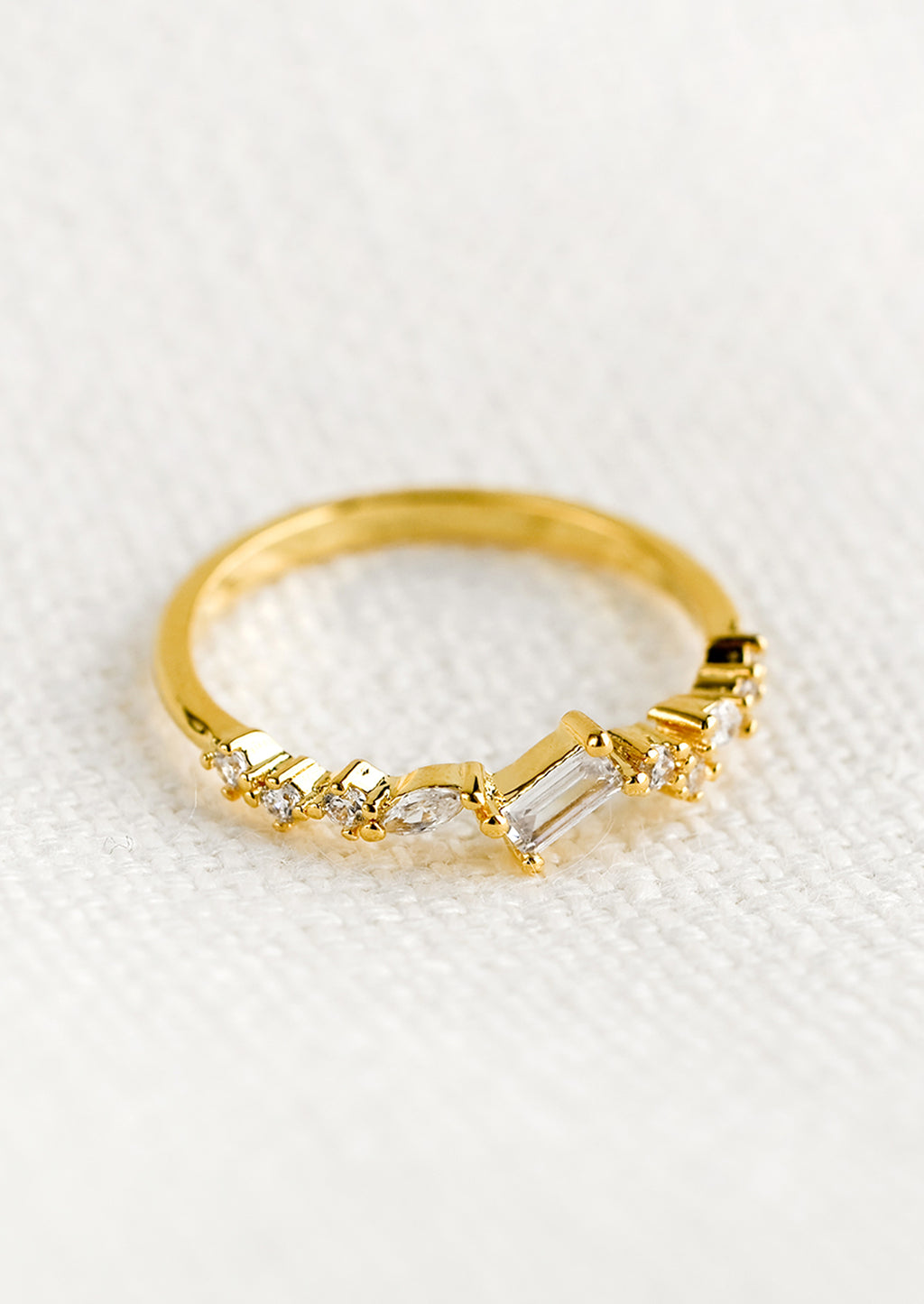 1: A gold ring with askew clear crystals in mixed cuts.