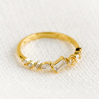 1: A gold ring with askew clear crystals in mixed cuts.