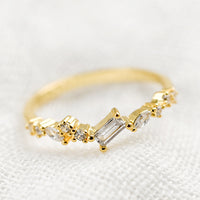 2: A gold ring with askew clear crystals in mixed cuts.