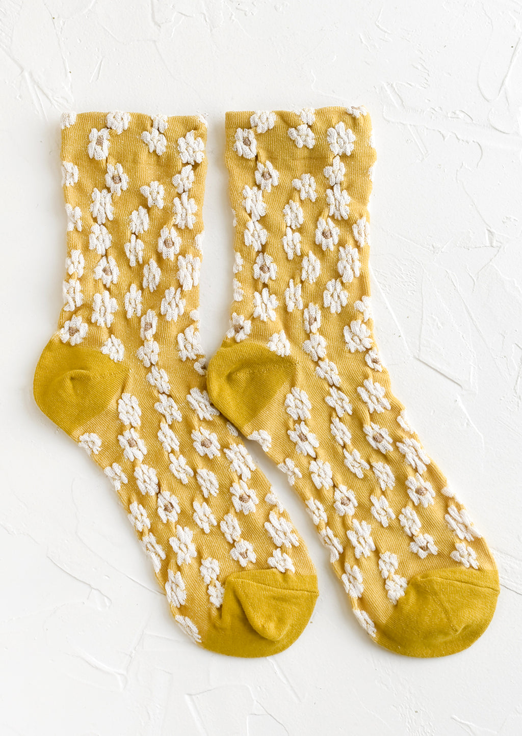 Yellow: A pair of non-sheer yellow socks with allover white daisy pattern.