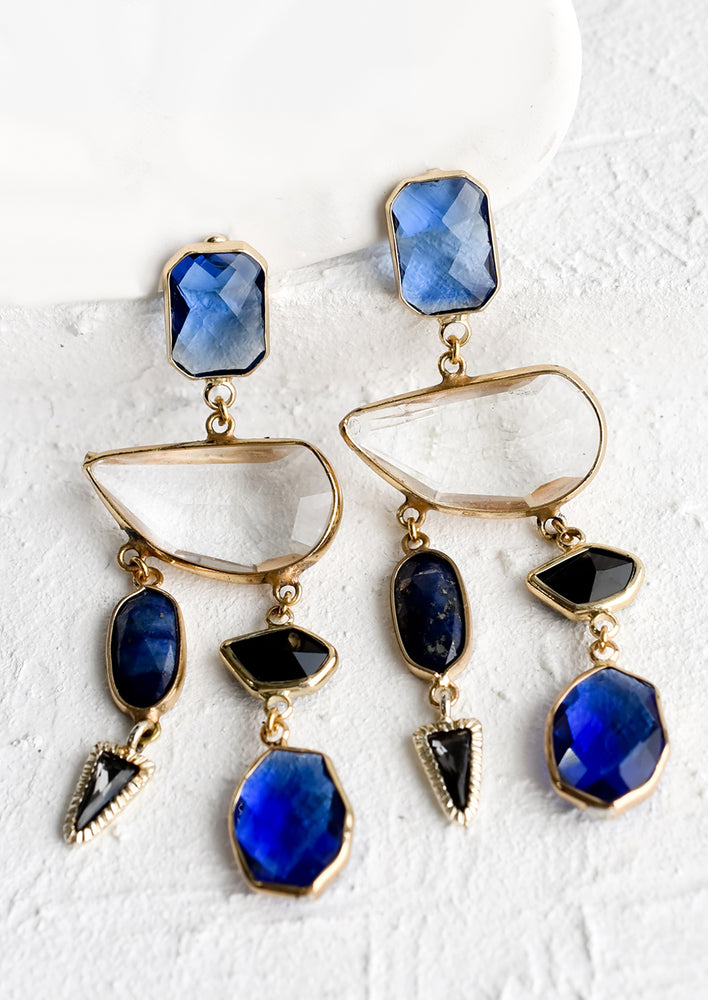 1: A pair of blue and clear glass and gemstone earrings with asymmetric shapes.
