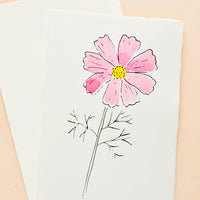 Cosmos: A white greeting card with a hand painted illustration of a pink cosmos flower.