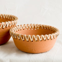 1: Terracotta bowl with decorative woven seagrass trim around top.