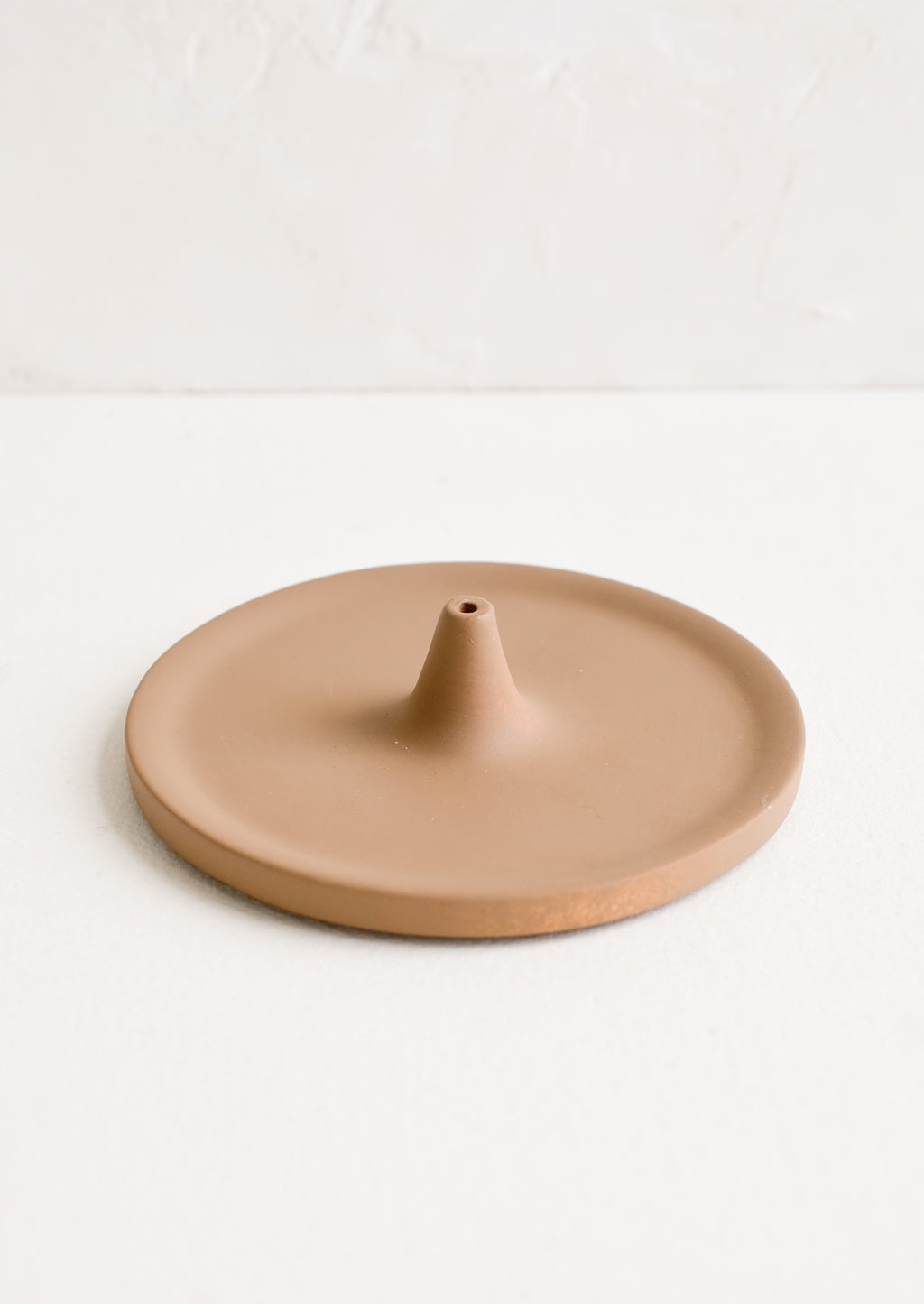 Matte Brown: A round incense holder in matte brown ceramic.