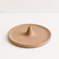 Matte Brown: A round incense holder in matte brown ceramic.