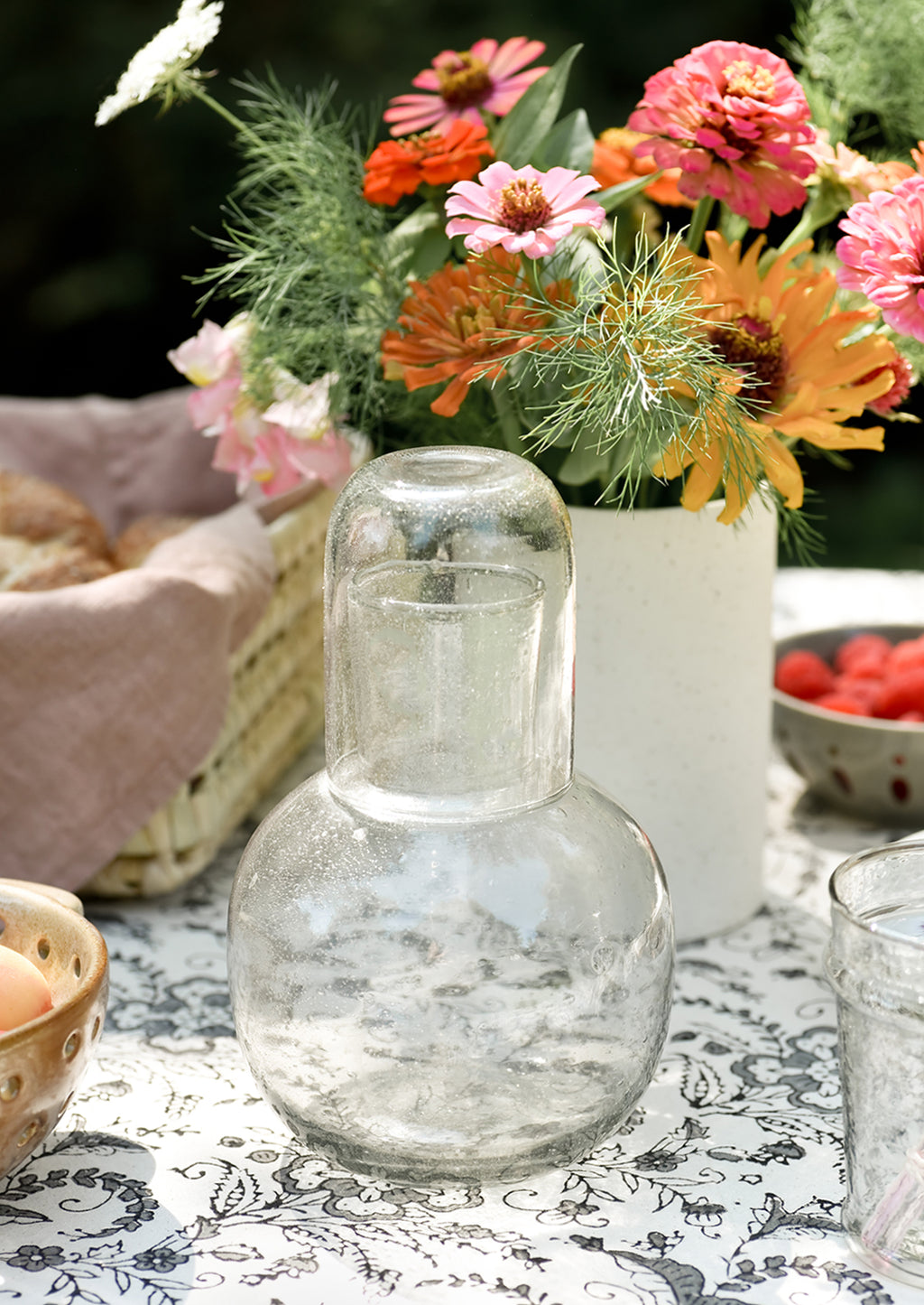 Clear: A set table with clear glass carafe.