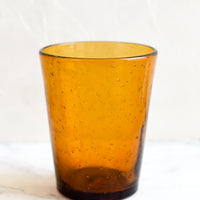 Amber: A glass tumbler cup in amber seeded glass.