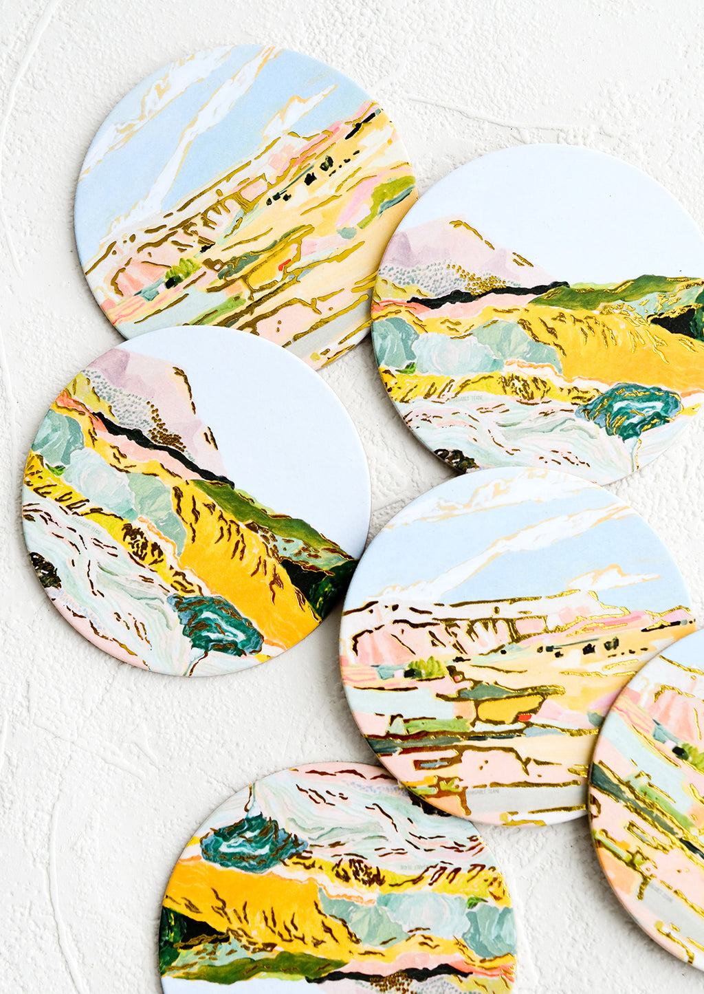 Amalfi Cliffs: A set of graphic print coasters with pastel imagery of mountains and cliffs.