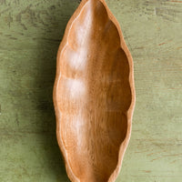 1: An elongated diamond or "seed pod" shaped wooden dish.