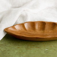 4: An elongated diamond or "seed pod" shaped wooden dish.