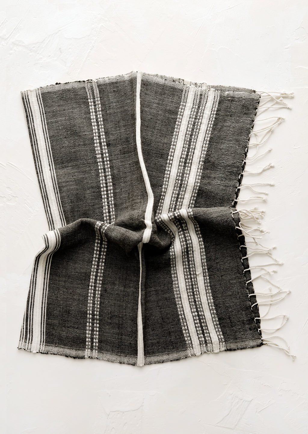 Charcoal: A cotton hand towel in black with woven natural stripes.