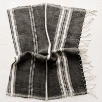 Charcoal: A cotton hand towel in black with woven natural stripes.
