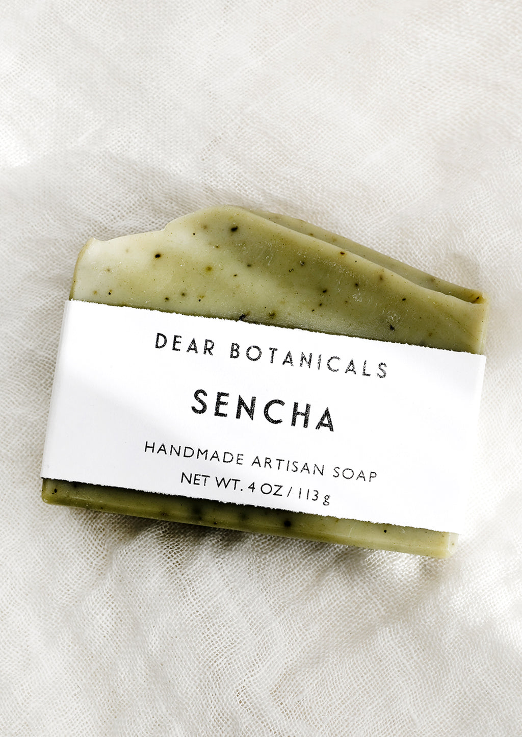 Sencha: A bar of soap in sencha scent (green with black speckles).