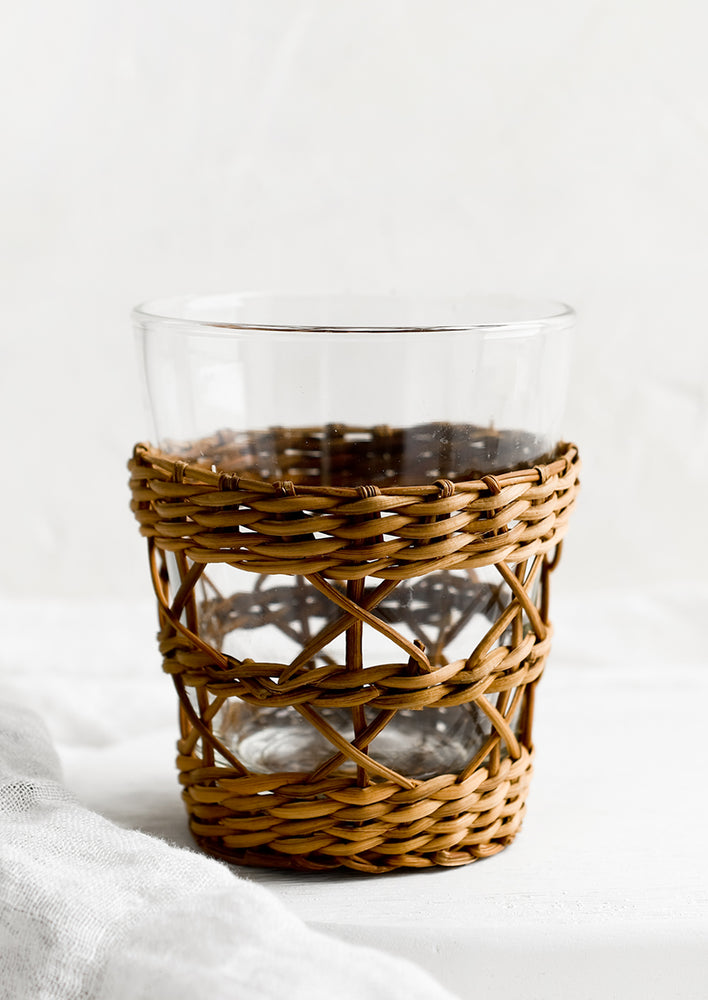 A glass cup with sepia tone seagrass cage.