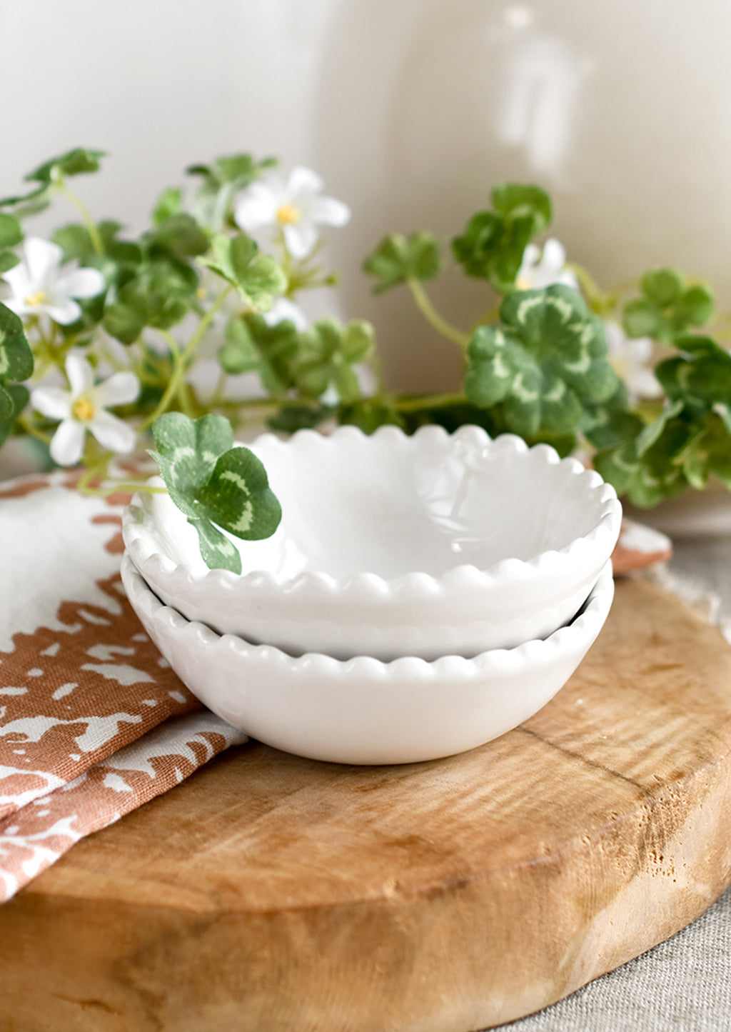 White: A small ceramic bowl with scalloped rim in white.