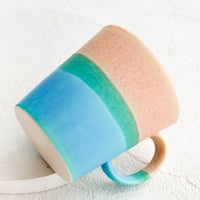 Pink / Turquoise: A ceramic coffee mug with handle in tri color pink and blue glaze.