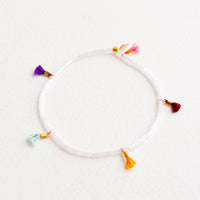 Rose Ice: Bracelet featuring white beads interspersed with 5 small multicolor string tassels on an elastic cord.