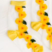 2: Sheer nylon sock with sunflower design and yellow trim.