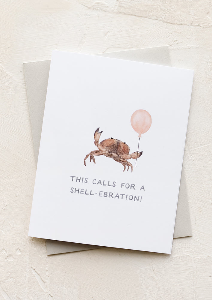 1: A greeting card with crab holding balloon.