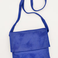 Sapphire: Bright blue soft leather bag with flap closure, cross body strap, and metallic sheen.
