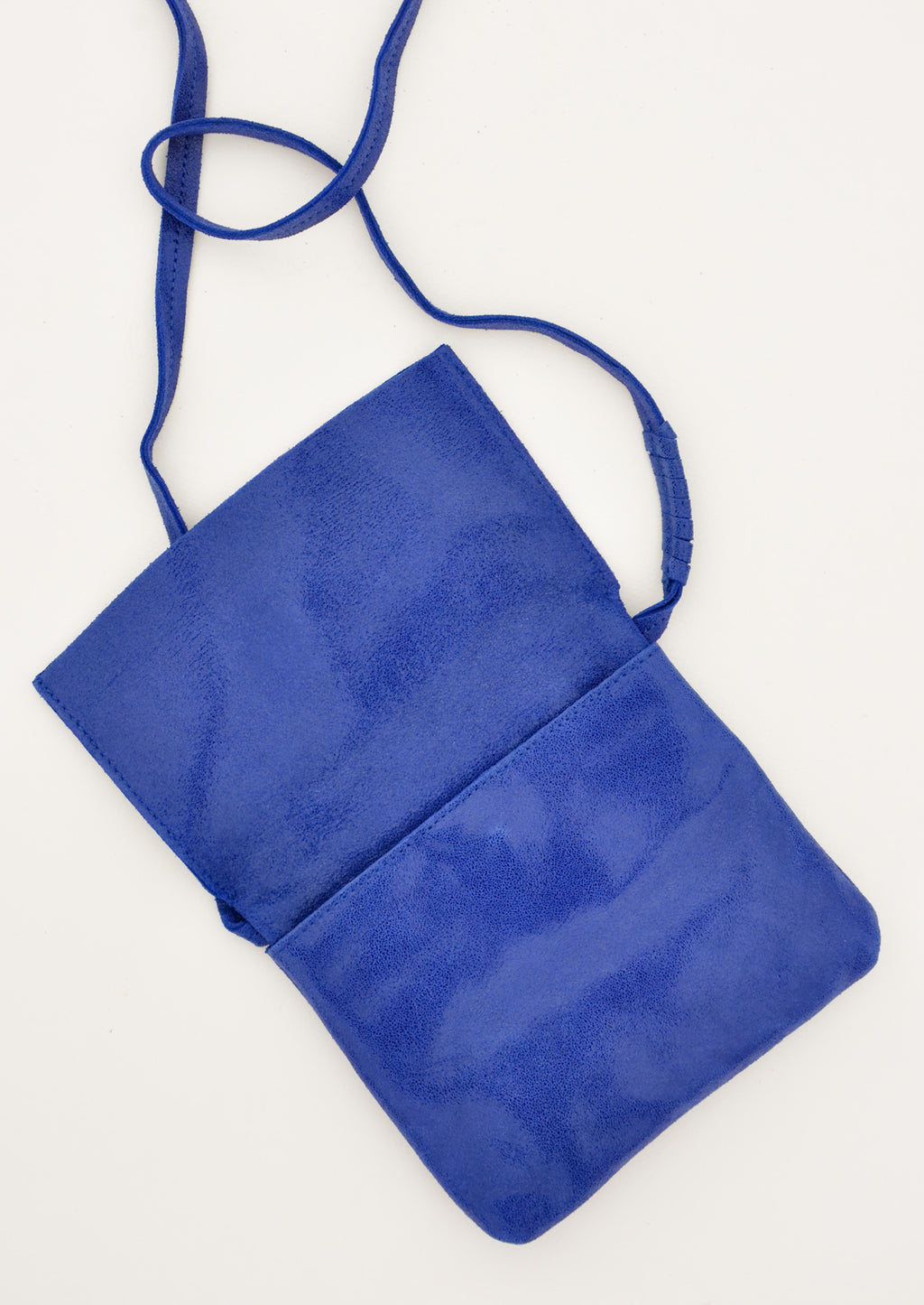 5: Bright blue cross body leather bag shown with flap upturned.