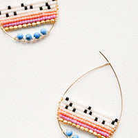Ivory / Turquoise Multi: Teardrop shaped hoop earrings in yellow gold with multicolored ivory and turquoise beaded bars across. 