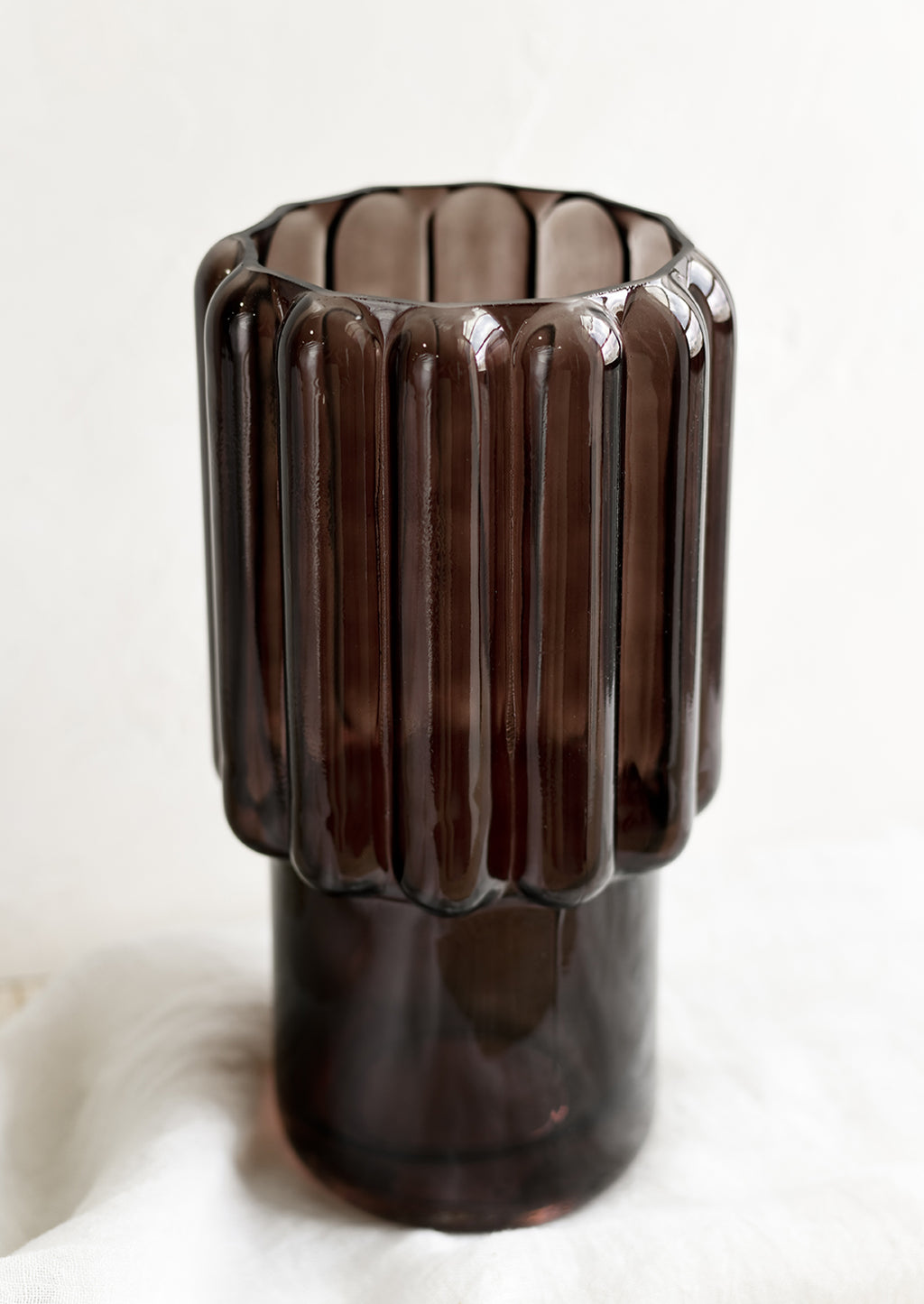 3: A large glass vase in dark brown with fluted texture.
