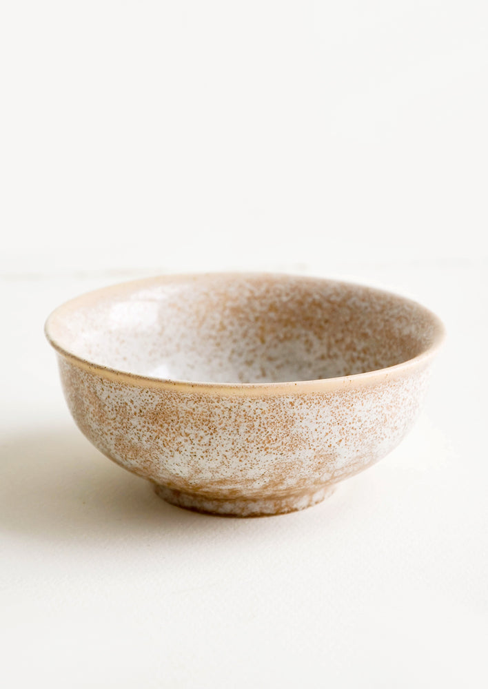 Small ceramic bowl with footed silhouette in reactive brown glaze