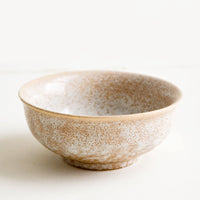 2: Small ceramic bowl with footed silhouette in reactive brown glaze