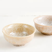 1: Small ceramic bowls with footed silhouette in reactive brown glaze