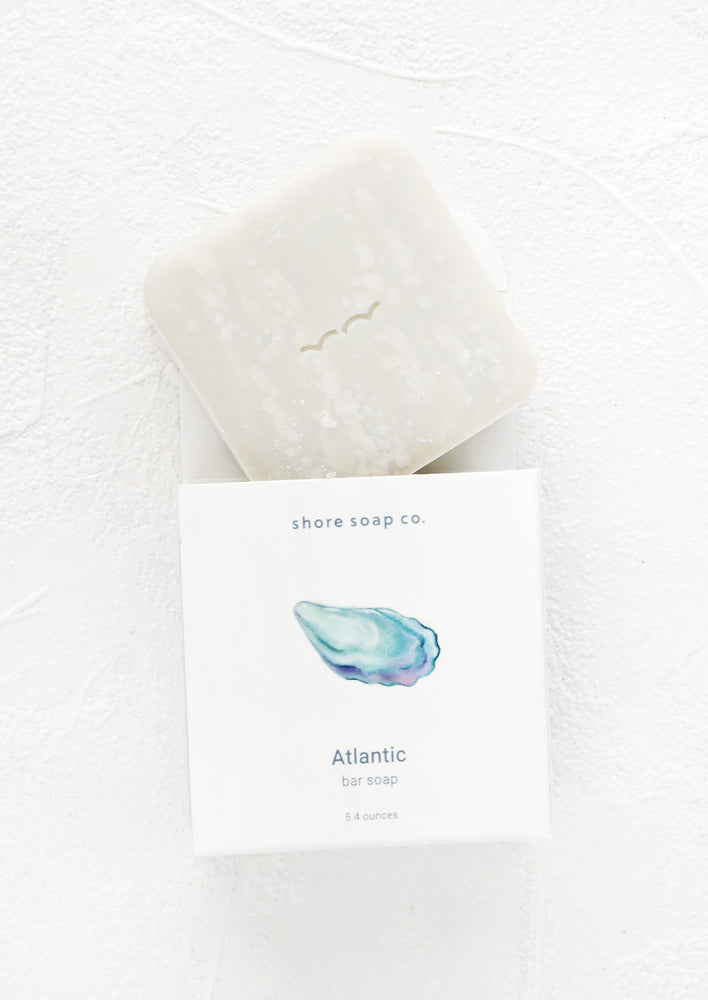 Square bar soap emerging from nautical themed packaging