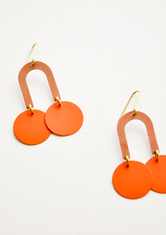 Dark Peach / Orange: Orange earrings form a curved arc with two discs at each end.