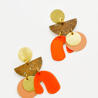 1: Earrings with layered circles and abstract shapes of gold, nude, bright orange and patina brass.