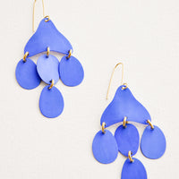 Cielo: Dangling earrings featuring 4 oval shape charms in matte bright blue metal hanging from an asymmetric triangle in the same color.