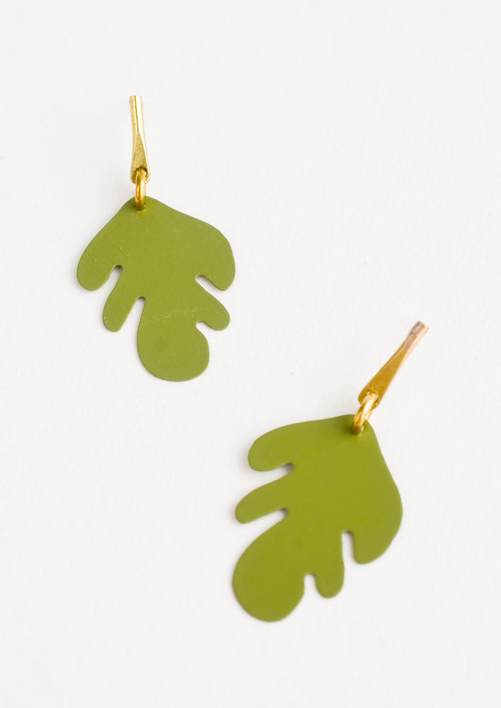 Metal earrings with green cutout leaf shape and brass bar post