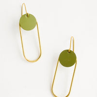 Olive: Pair of earrings in the shape of a hollow brass oval with a green dot at the top.