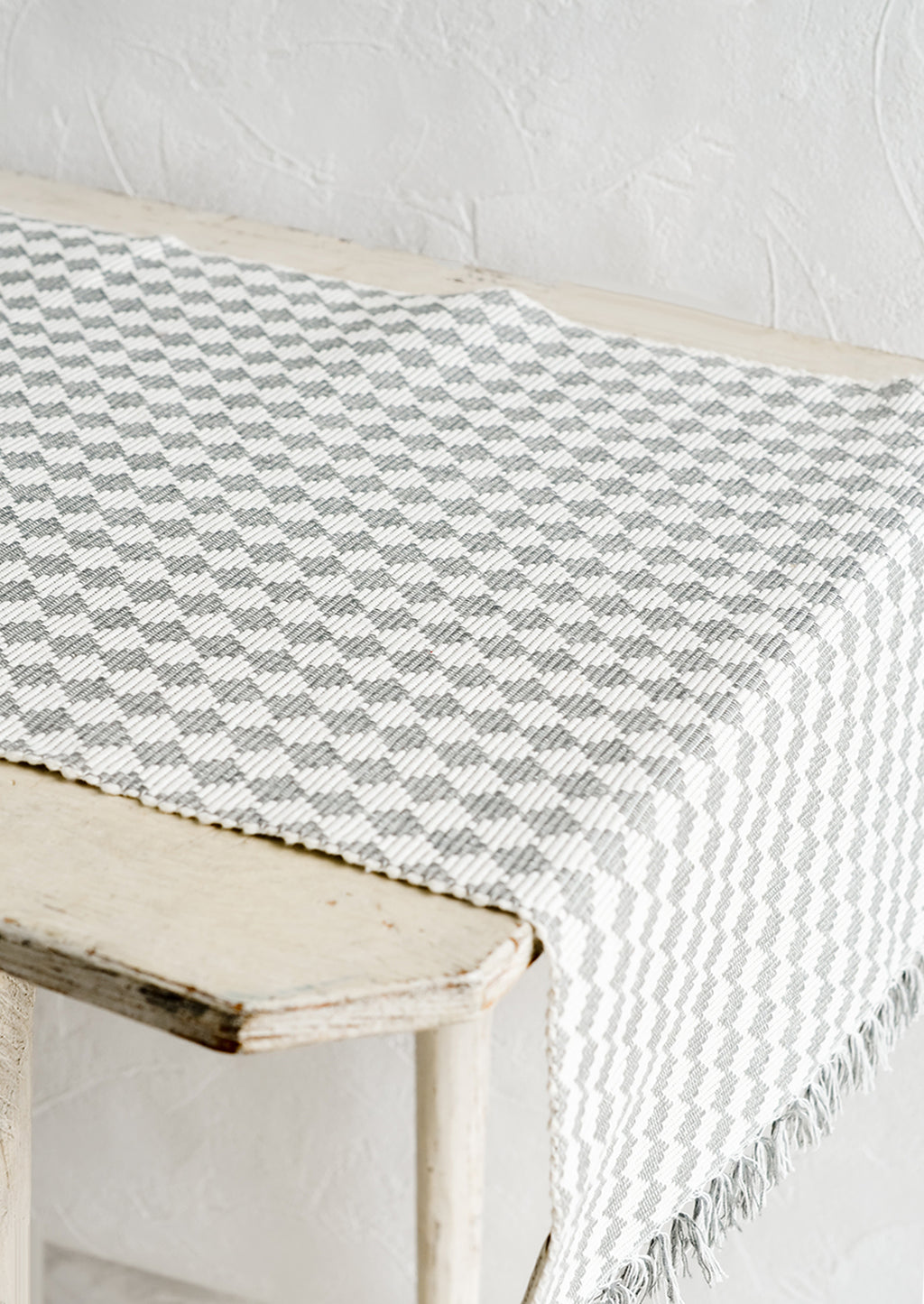 1: A table runner in ribbed textured grey and white checker print.