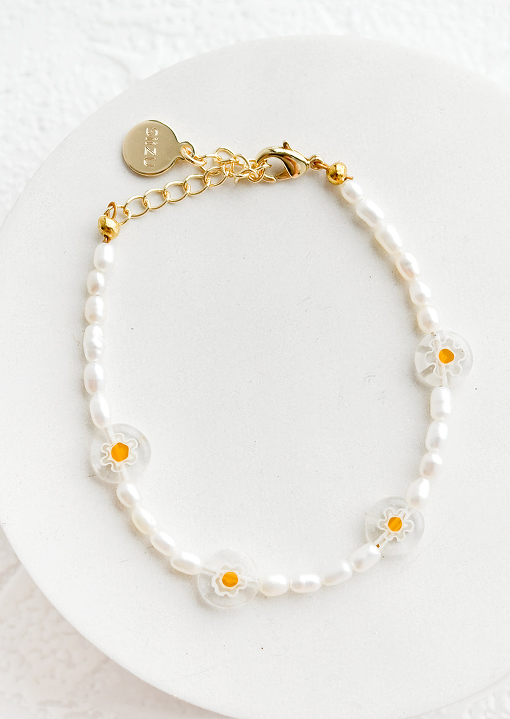 Yellow Flowers: A pearl beaded bracelet with clear millefiore glass daisy beads.