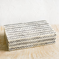 3: A decorative storage box made from ivory bone with black etched "slash" pattern.