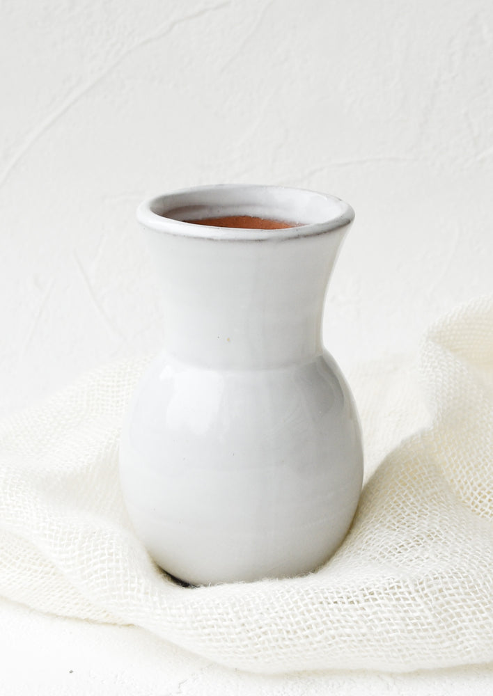 Glossy white ceramic vase with wide bottom and tapered top